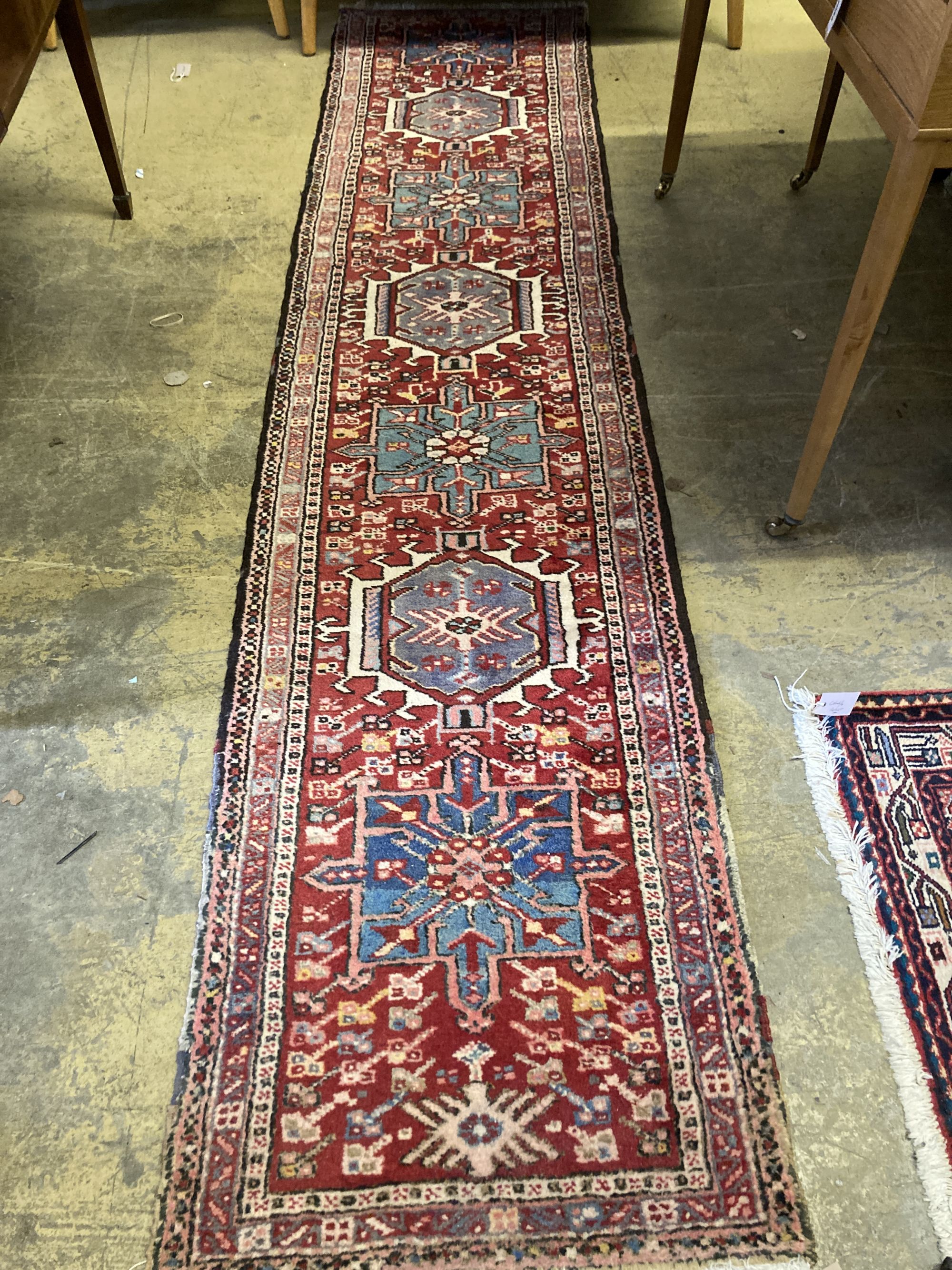 A Caucasian red ground runner, 296 x 64cm